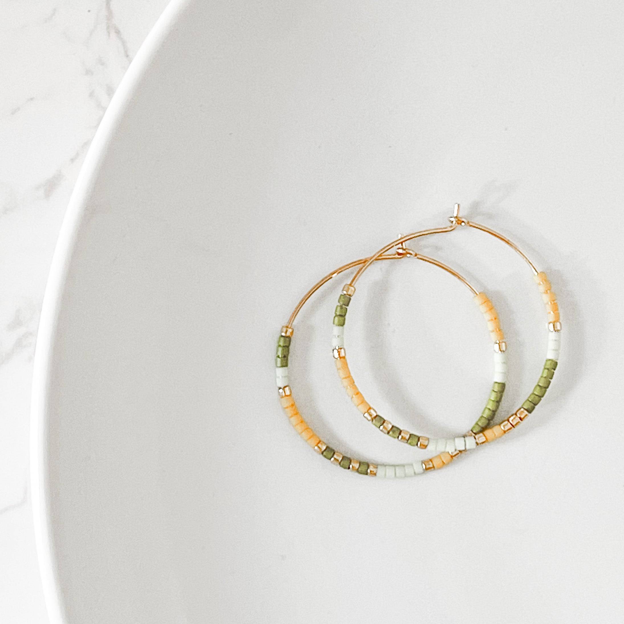 Lemon Lime colorway of Summer Edition - Beaded Hoop Earrings with green, yellow, and gold seed beads on gold hoops, displayed on a white plate.