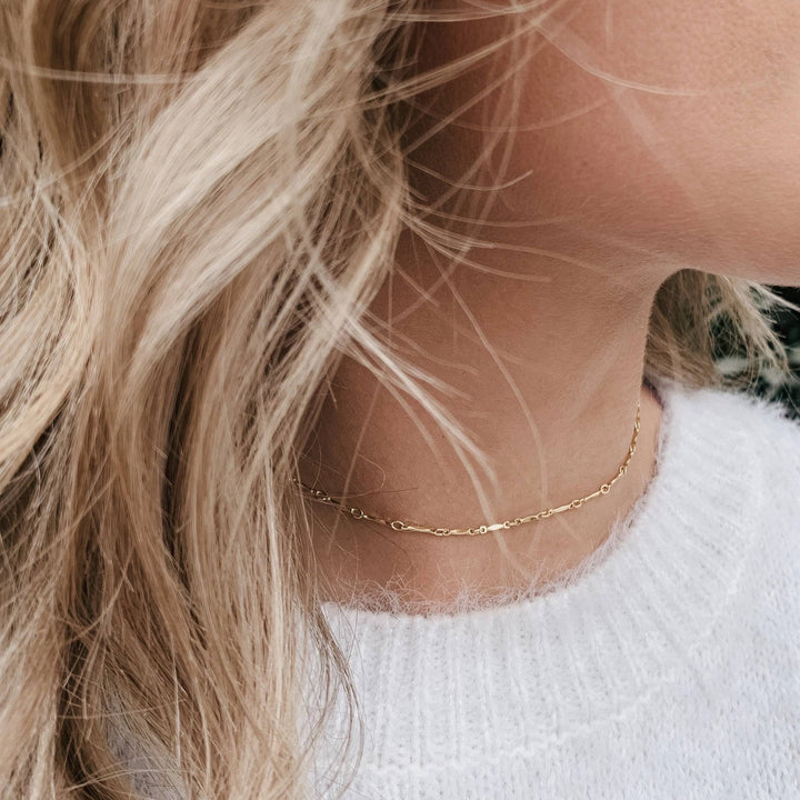 Woman wearing Layering Dainty Bar Necklace by Barberry & Lace, showcasing its elegant, minimalist style perfect for layering or solo wear.
