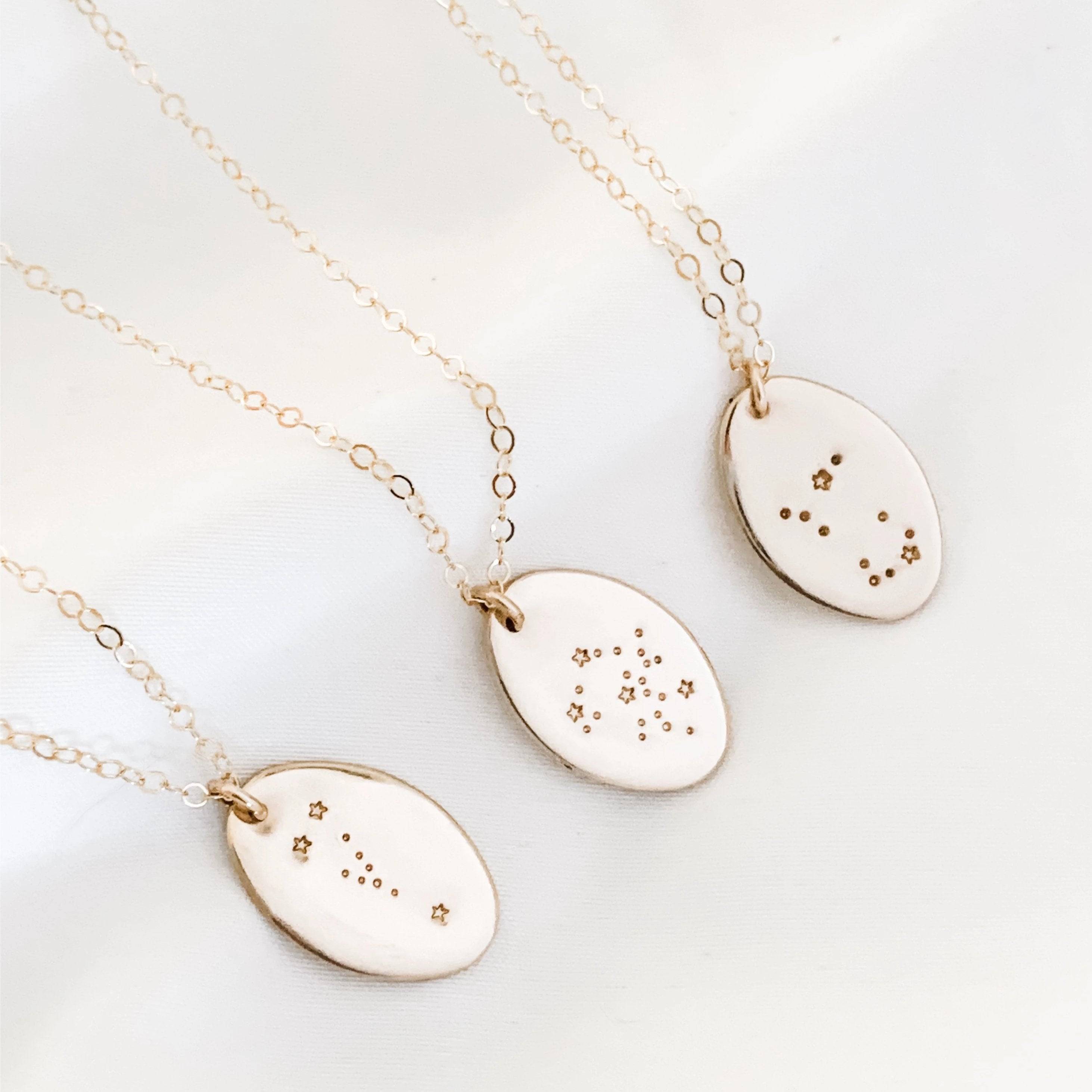 Hand Stamped Constellation Necklace by Barberry & Lace Jewelry featuring sterling silver or 14k gold filled oval pendants with star patterns.