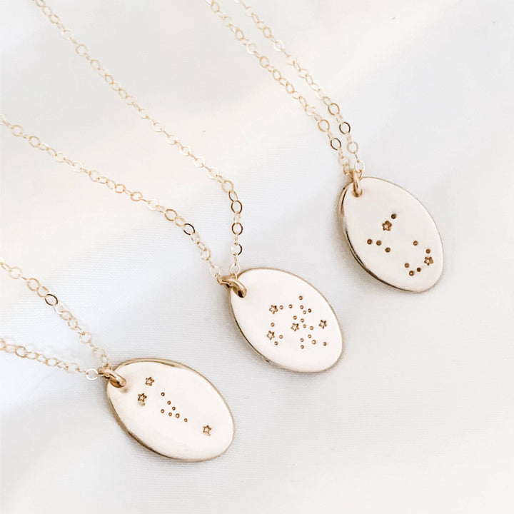 Hand Stamped Constellation Necklace by Barberry & Lace Jewelry featuring sterling silver or 14k gold filled oval pendants with star patterns.