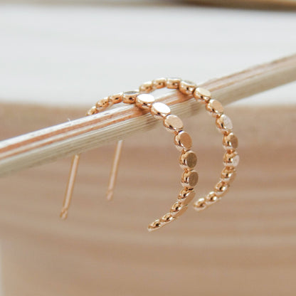 Close-up of Barberry & Lace Pebble Hoop Stud Earrings with polished pebble detailing, ideal for modern jewelry collections.