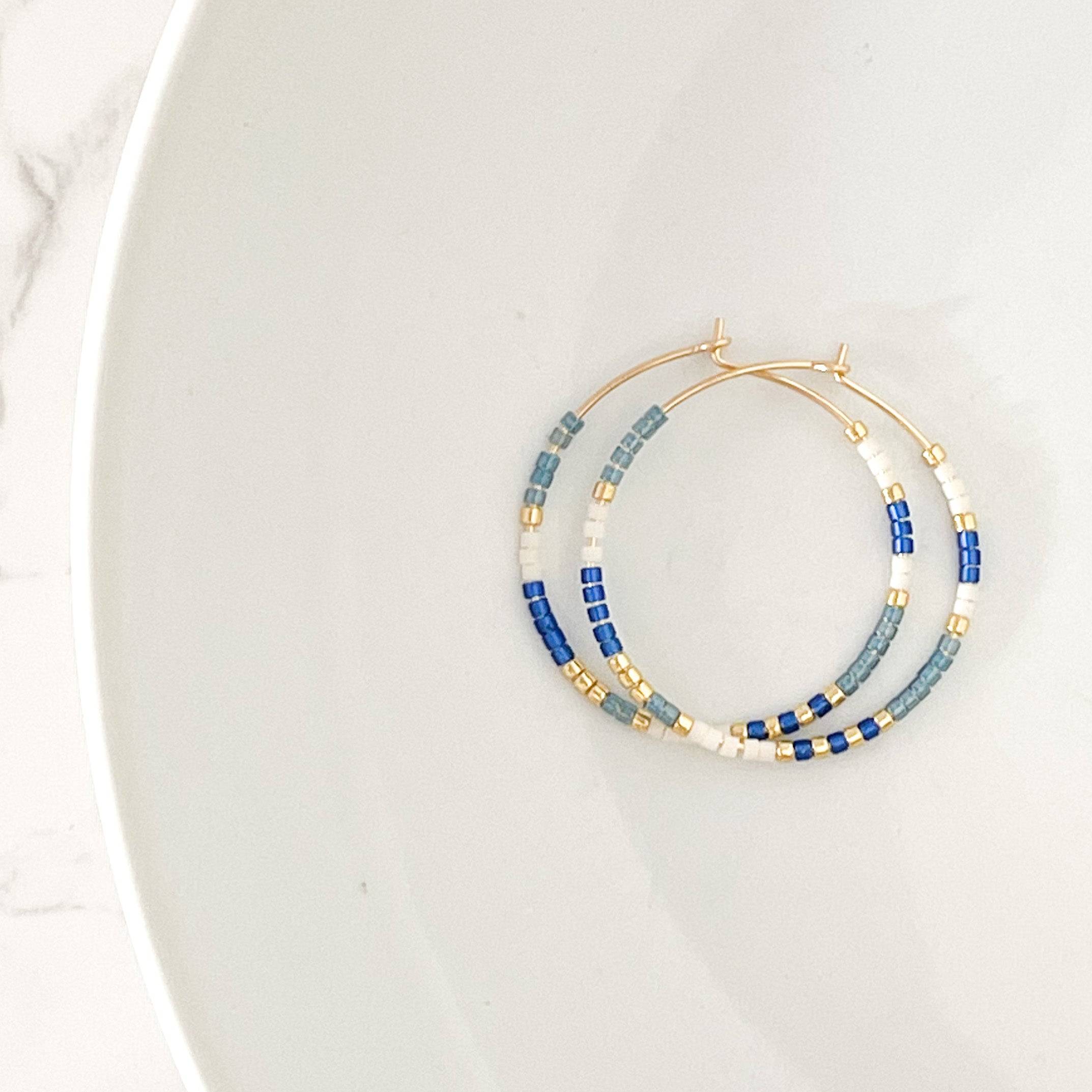 Ocean colorway of Summer Edition - Beaded Hoop Earrings featuring blue, white, and gold seed beads on gold hoops, styled on a white background.