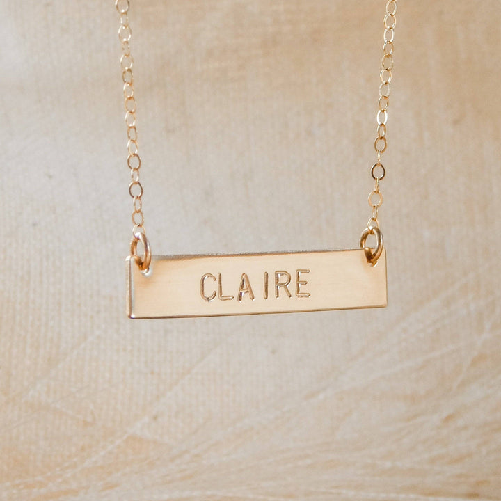 Personalized Bar Necklace by Barberry & Lace Jewelry featuring the name 'Claire' engraved on a 14k Gold Fill bar, ideal for sensitive skin.