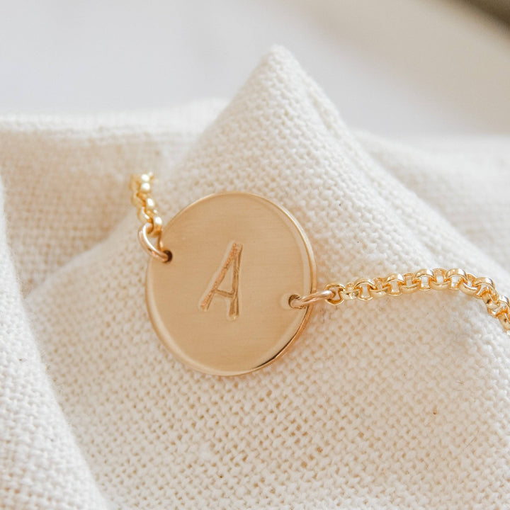 Personalized Disc Bracelet by Barberry & Lace Jewelry featuring a hand-stamped initial 'A' on a 14k gold fill disc with a delicate chain.