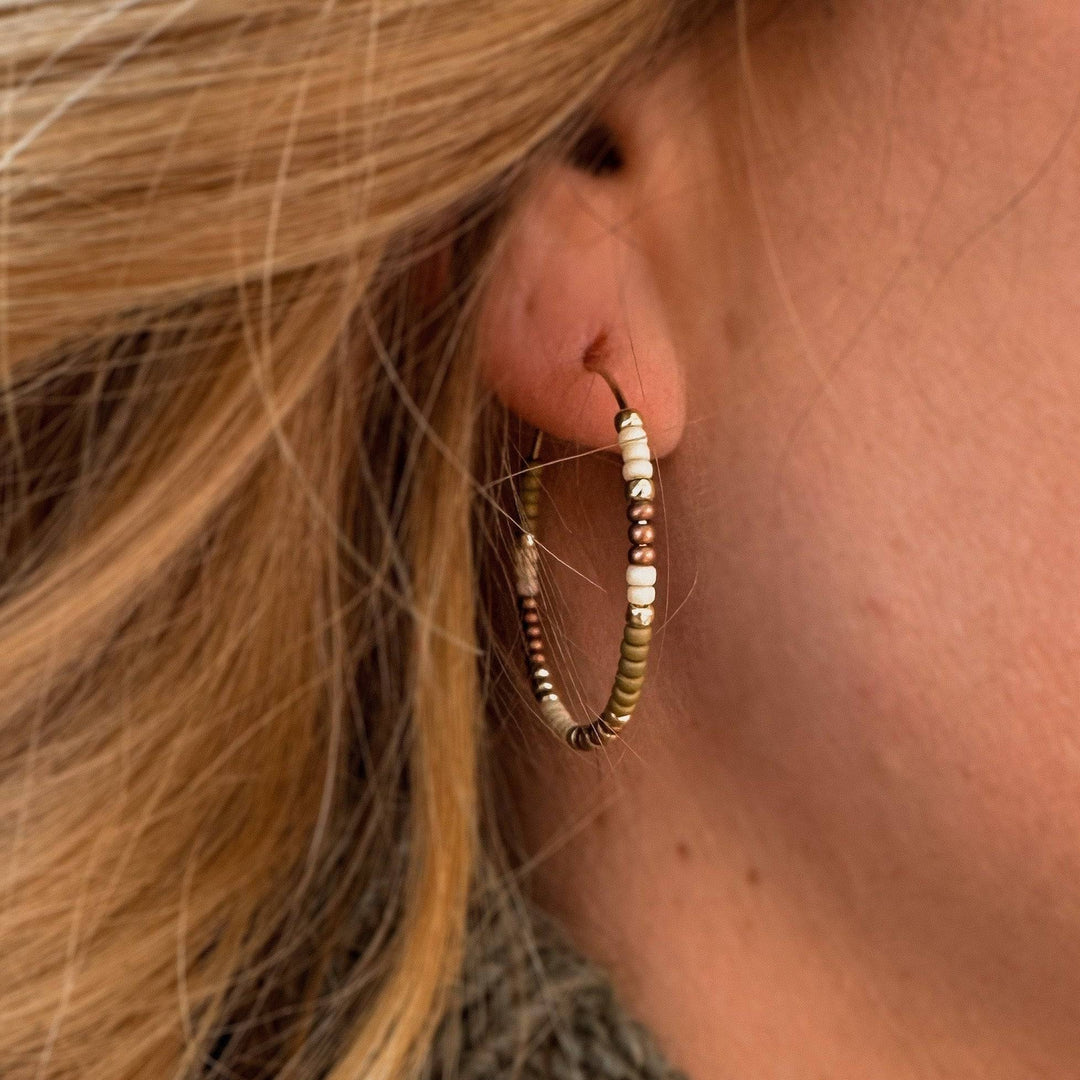 Holiday Edition - Beaded Hoop Earrings worn on ear, showcasing earthy tones and gold accents. Lightweight and hypoallergenic for daily wear.